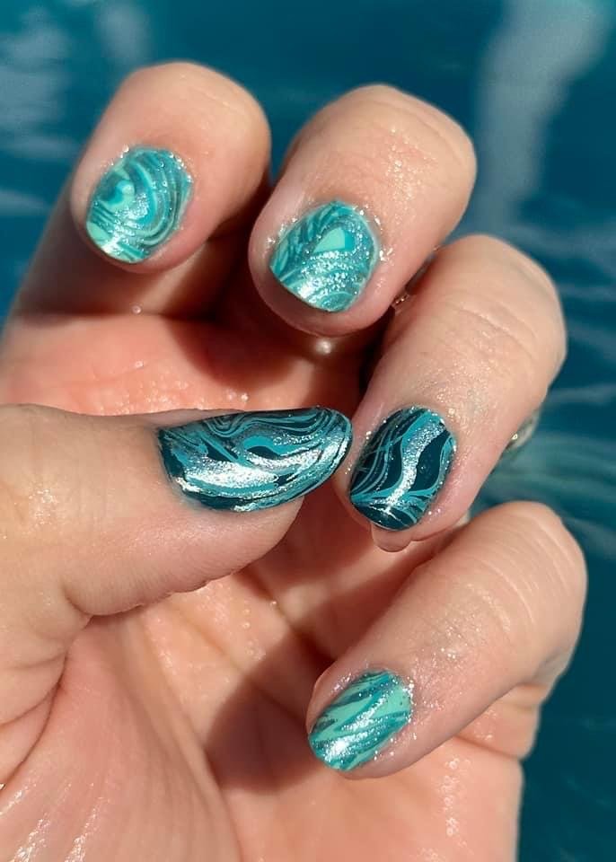 Turquoise marble nail art with glitter ocean water backdrop