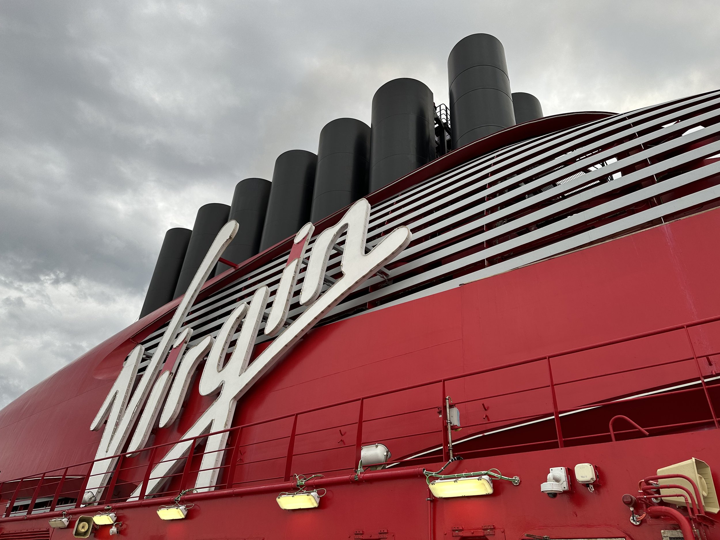 Cunard cruise ship with distinctive black funnels and red hull