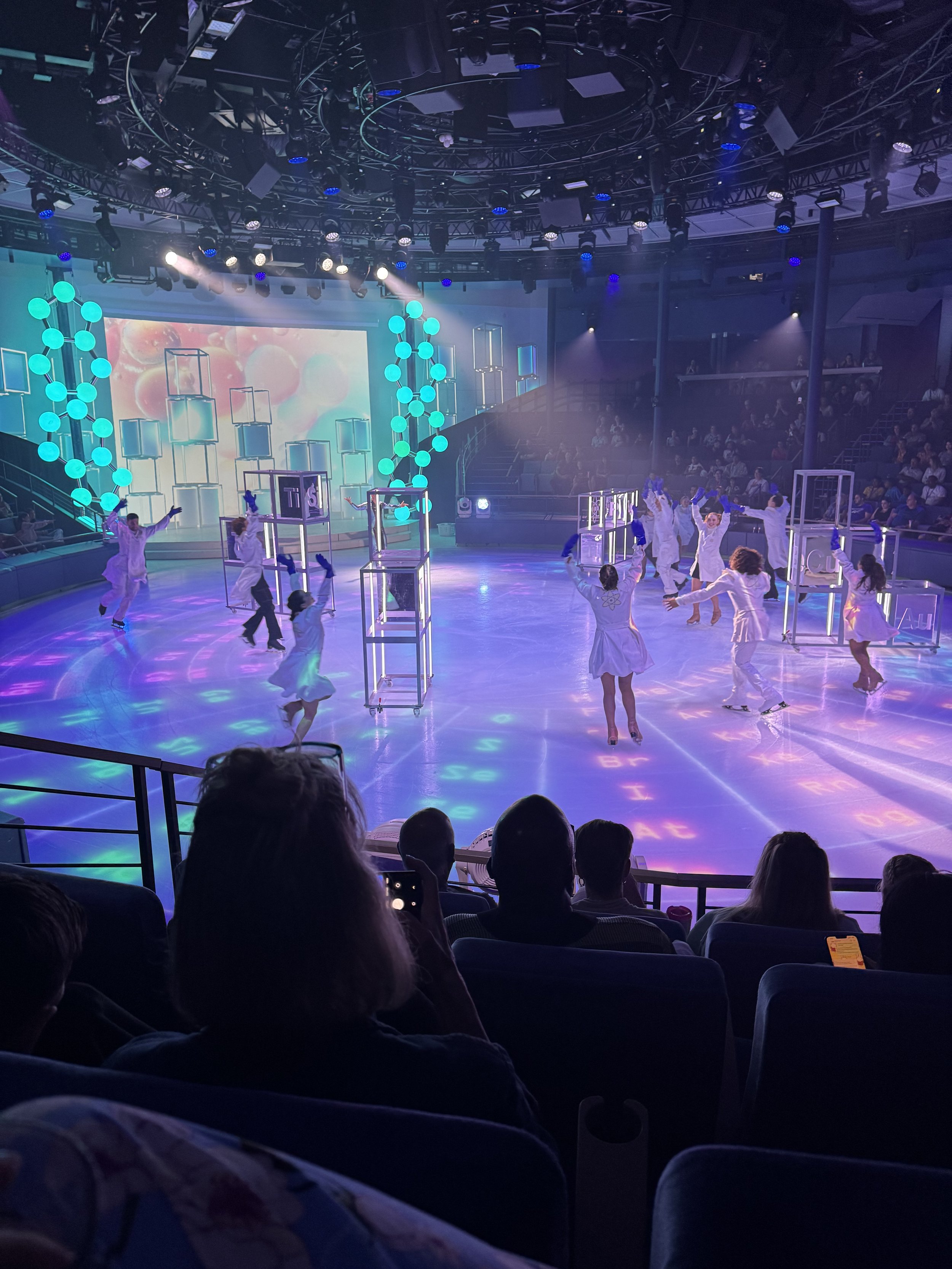 Children performing dance on illuminated cruise ship stage