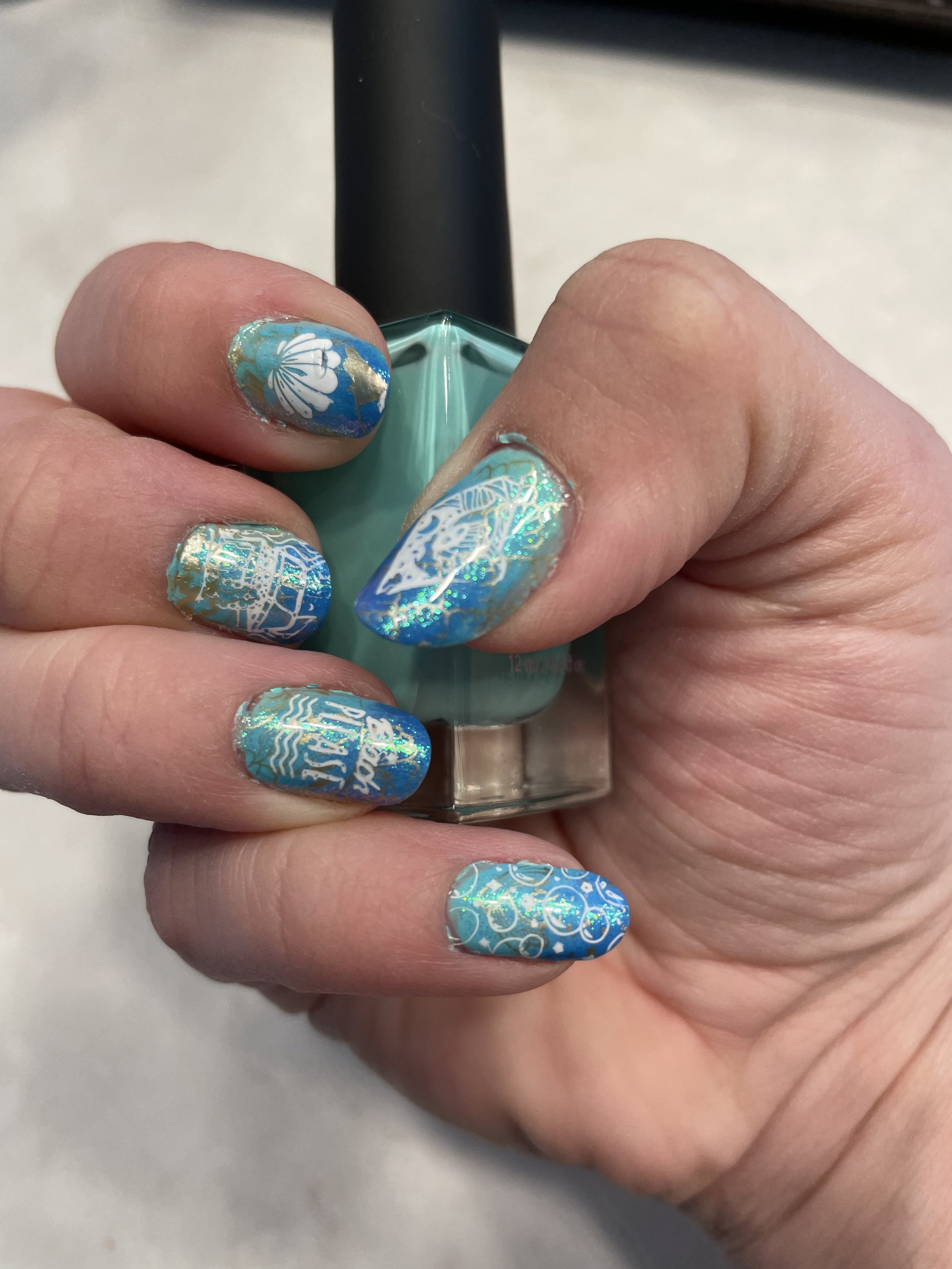 Ocean-themed nail art with sea creatures and shells design