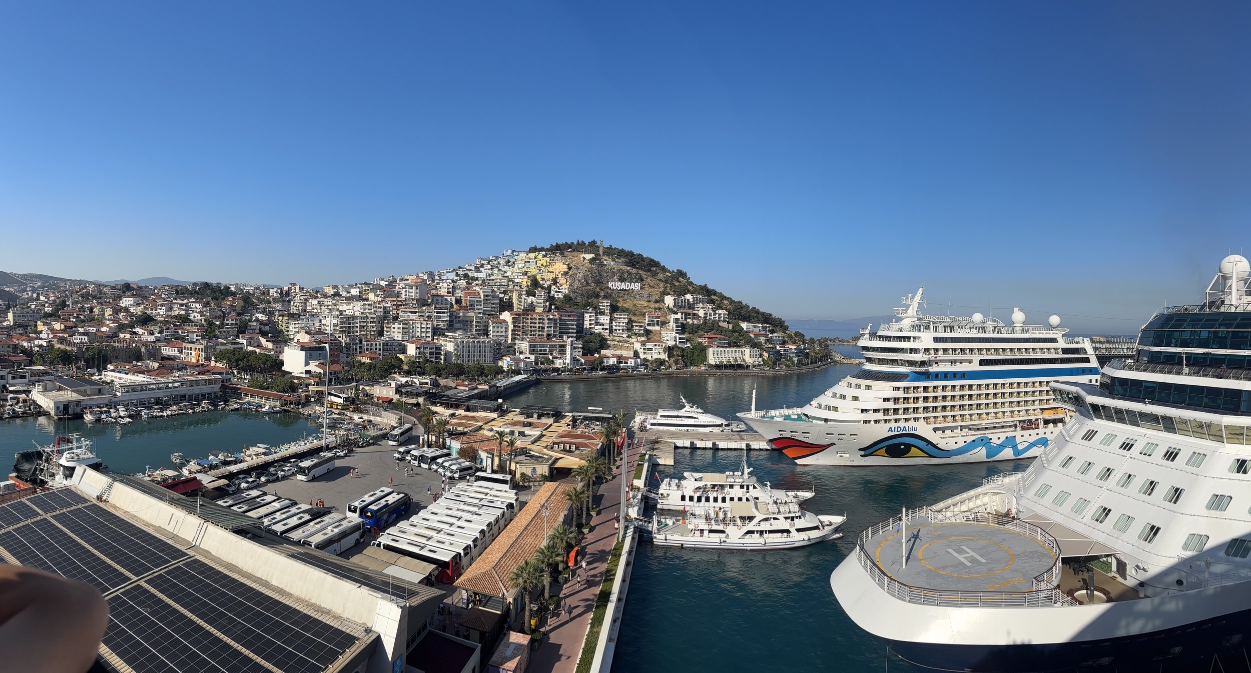 Multiple cruise ships docked at Alanya Turkey port with hillside town
